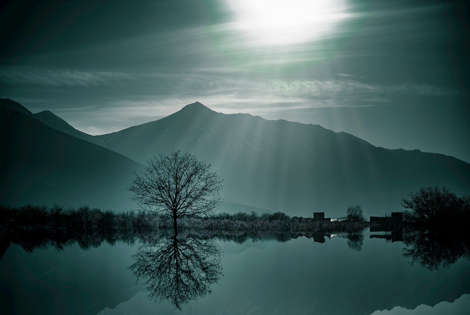 body of water with mountains nearby